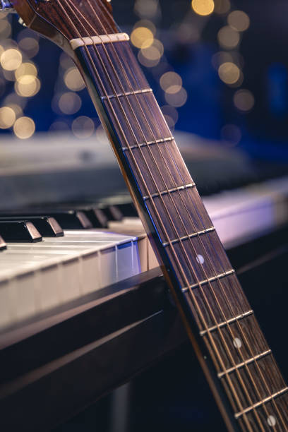 istock Guitar and piano keys close-up on a blurred background with bokeh. 1689088135