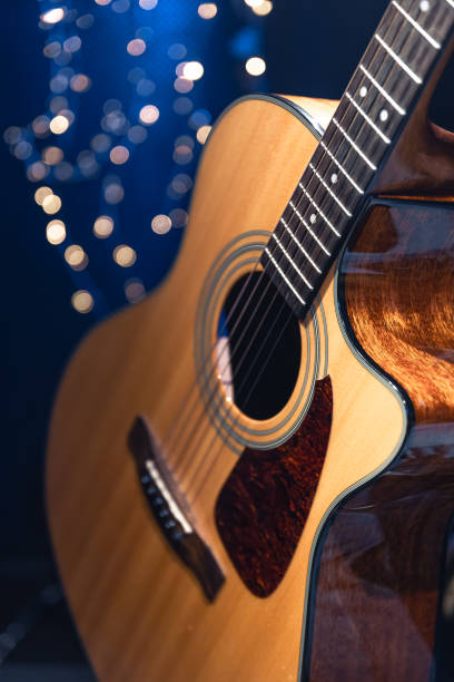 istock Close-up, acoustic guitar on a dark background with bokeh lights. 1689088193