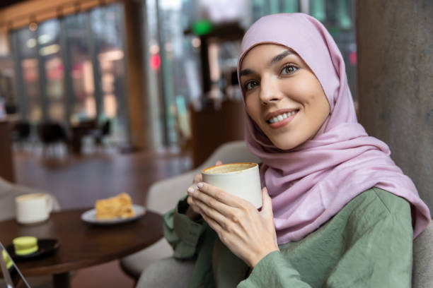 istock Cute smiling woman having coffee and looking enjoyed 1689100665