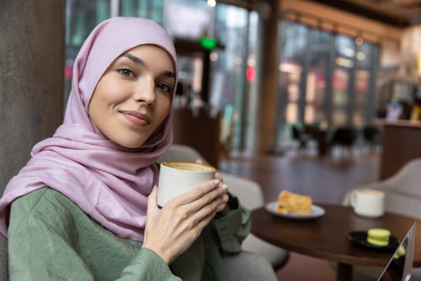 istock Cute smiling woman having coffee and looking enjoyed 1689100687
