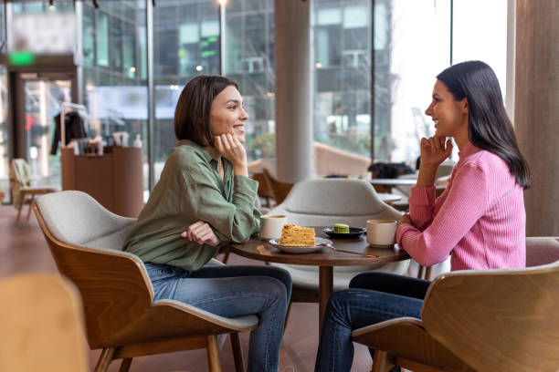istock Two friends talking in a cafe and looking involved 1689101817