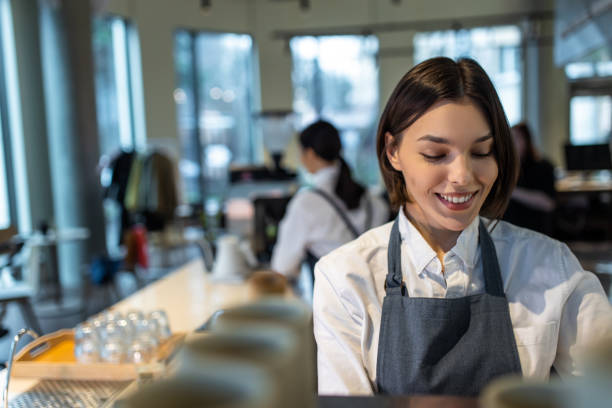 istock Coffee shop assistant preparing coffee in a coffee store 1689103076