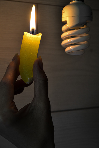 a candle near a light bulb