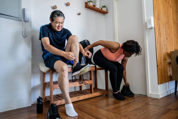 Pilates students getting dressed and tying shoe at gym