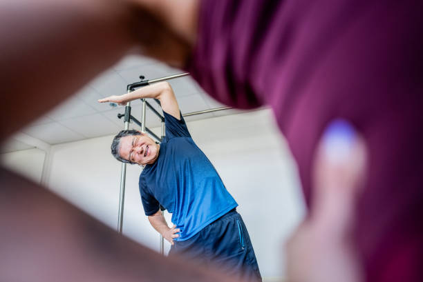 senior man doing exercises at pilates studio - yoga men male gymnastics foto e immagini stock