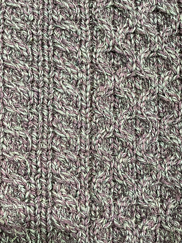 Stock photo showing close up stitched design of a chunky knit aran jumper.