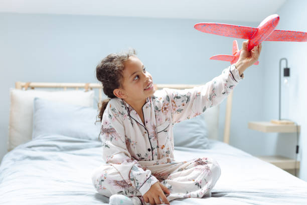 istock Little girl playing with toy plane 1689144617