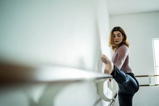 Young woman stretching at the dance studio