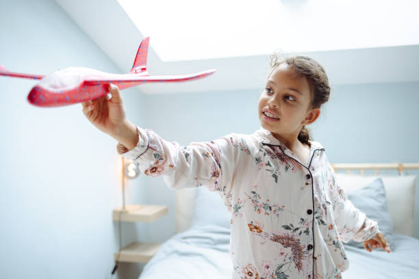 istock Little girl playing with toy plane 1689152204