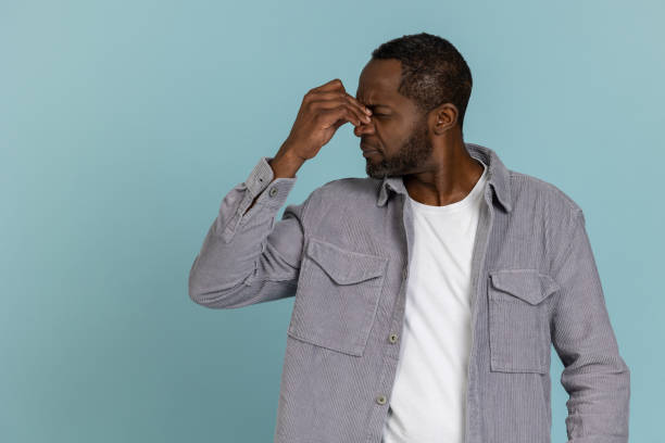 istock Unhappy black man wearing gray shirt grimacing 1689152753