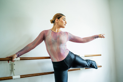 Young woman stretching at the dance studio