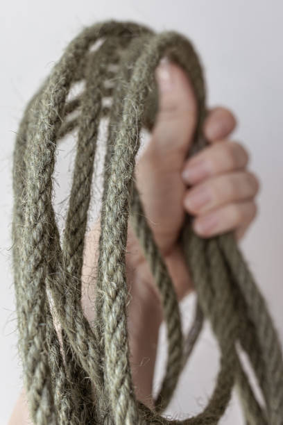 istock Rough rope in a woman's hand 1689168135