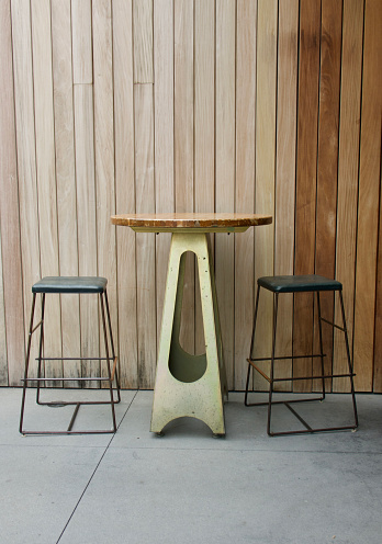 Outdoor cocktail table and a pair of stools
