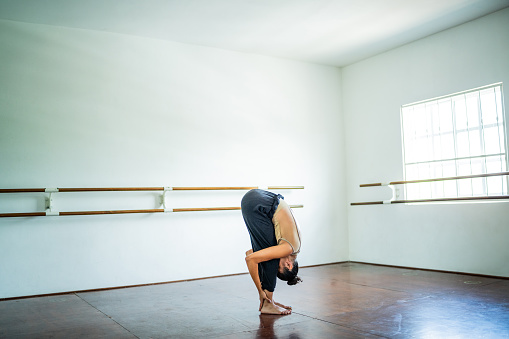 Young woman stretching at the dance studio