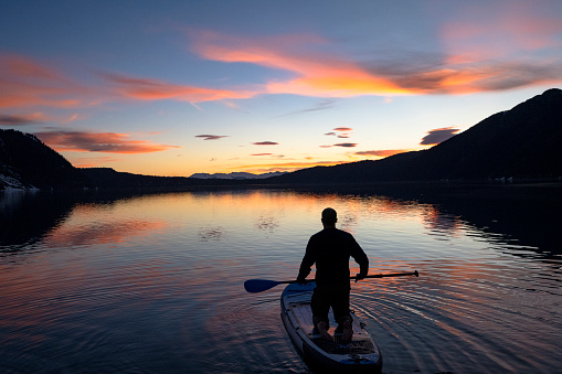 Adventure and active lifestyles themes. Paddleboarding in Whistler, Canada. Man living a life with purpose.