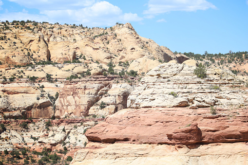 Color landscape photograph of a rocky wall showing the geological layers within a canyon in rural Colorado.
