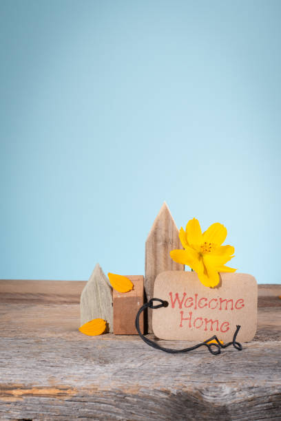 Welcome home banner or note with bright yellow flowers.