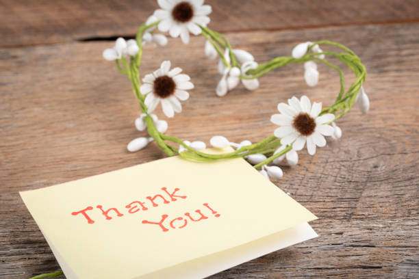istock Thank you! on a note card with a heart shaped daisy flower chain. 1689197904