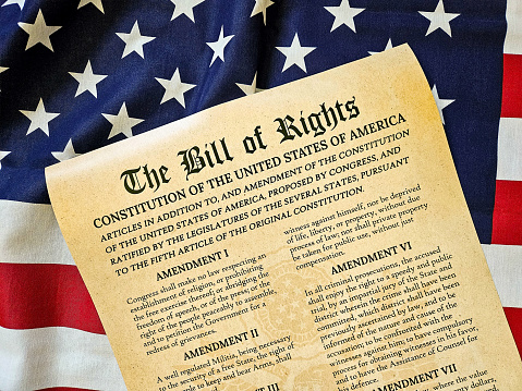 US Constitution with Betsy Ross 13-star Flag and Blue Sky Background