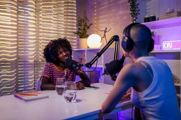 istock African girl is sitting in a home podcast studio with a host 1689211110