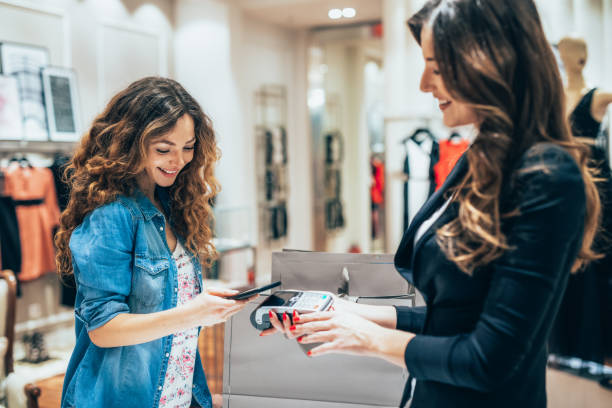 istock Paying via smart phone at a clothing store 1689239122