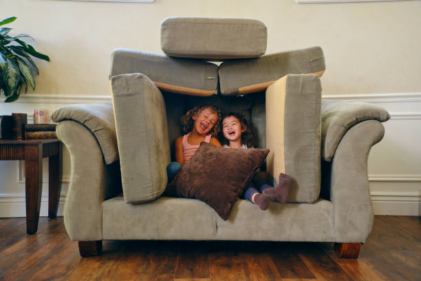 Children Playing in a Home Living Room on a Play Date Two little girls, playing in the living room of a home on a play date. fort stock pictures, royalty-free photos & images