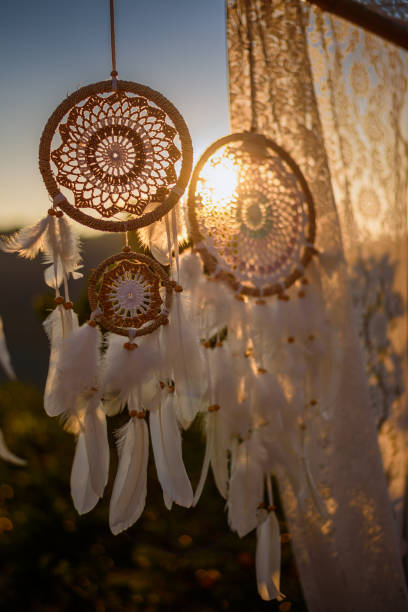 istock White Dreamcatcher in sunset sky, american native amulet 1689247577