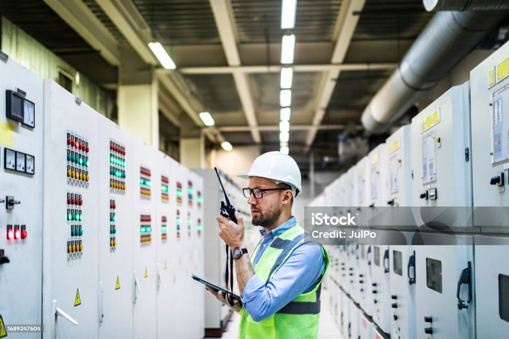 Checing Power Electrical Engineer Checking Power At Control Room Using Digital Tablet ...