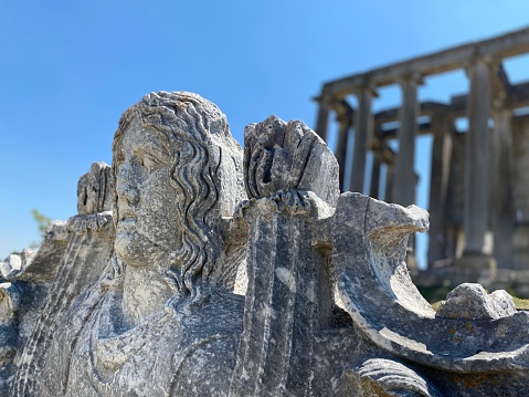 Ancient Greek god statue in front of the Zeus temple in the ancient city of Aizanoi, Kutahya, Turkey