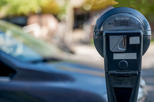 Selective focus on an expired parking meter with no time left. High quality photo