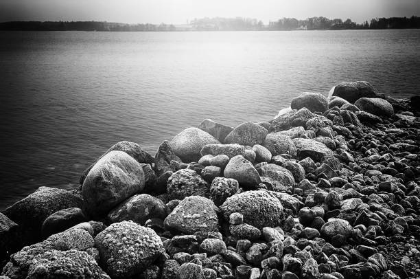 Rocks by water in black and white with film noir feeling
