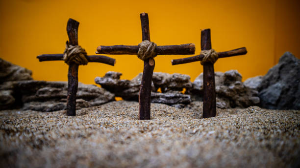 istock crosses stuck in the sand on an orange background 1689506190