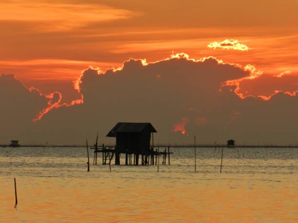 istock Silhouette fisherman's hut with during sunset 1689593871