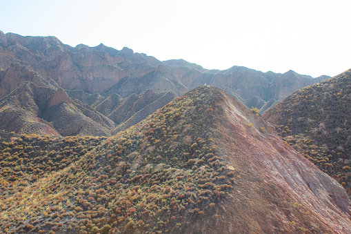 Beautiful landscape of typical landform at Binggou Danxia Scenic Area, Zhangye, Gansu, China. Martian red rocks, blue sky with copy space for text
