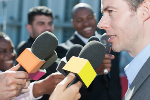 Media interview, news reporter holding microphone in next to spokesperson, Nikon Z7