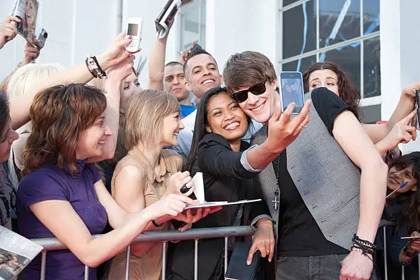 Photo of Celebrity taking pictures with fans