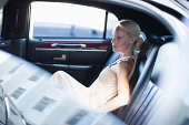 Woman sitting in backseat of limo