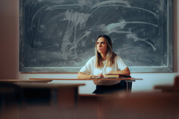 istock Stressed Teacher Sitting at the Desk Feeling Overwhelmed 1689623193