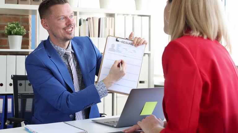 Smiling businessman shows resume blank to businesswoman 4k movie