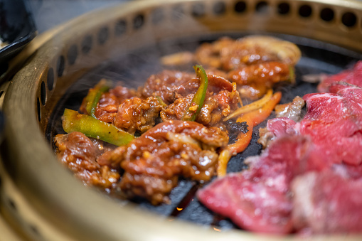 Macro Photo of Korean BBQ with meat cooking on the grill