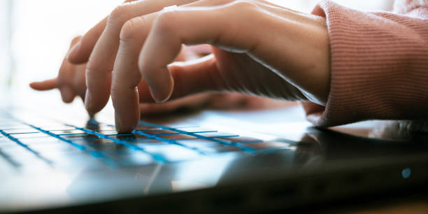 istock Low angle closeup view of female hands typing on laptop computer keayboard 1689660369