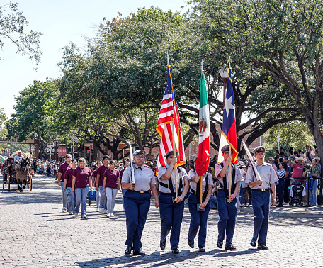 Fort Worth, Texas, USA - September 17, 2023: US Reserve Officer Training Corp (ROTC) carries the American, Mexican, and Texas flags in the National Hispanic Heritage Month Parade at Fort Worth Stockyards.