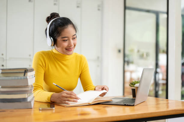 istock A beautiful young Asian female university student is studying an online class or lecture. 1689811685