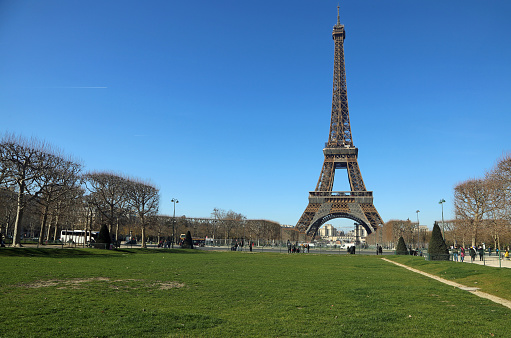 Historic Eiffel Tower (Tour Eiffel) from 19th century standing on Champs de Mars in Paris, France