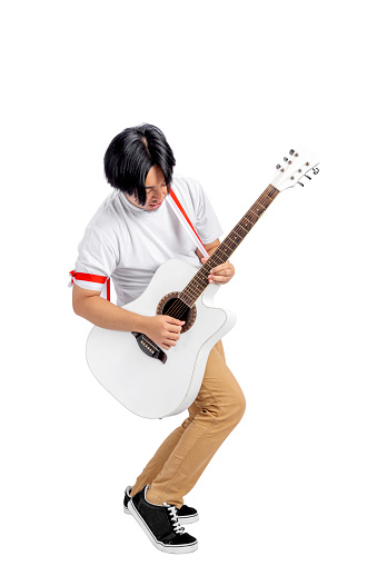Indonesian men celebrate Indonesian independence day on 17 August while holding guitars and playing music isolated over white background