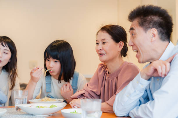 istock Large family eating dinner together 1689862521