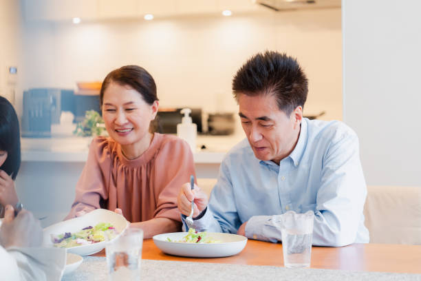 istock Large family eating dinner together 1689862531