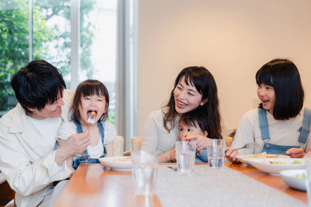 istock Large family eating dinner together 1689862541