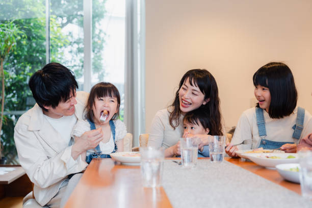 istock Large family eating dinner together 1689862544
