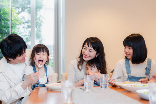 istock Large family eating dinner together 1689862548